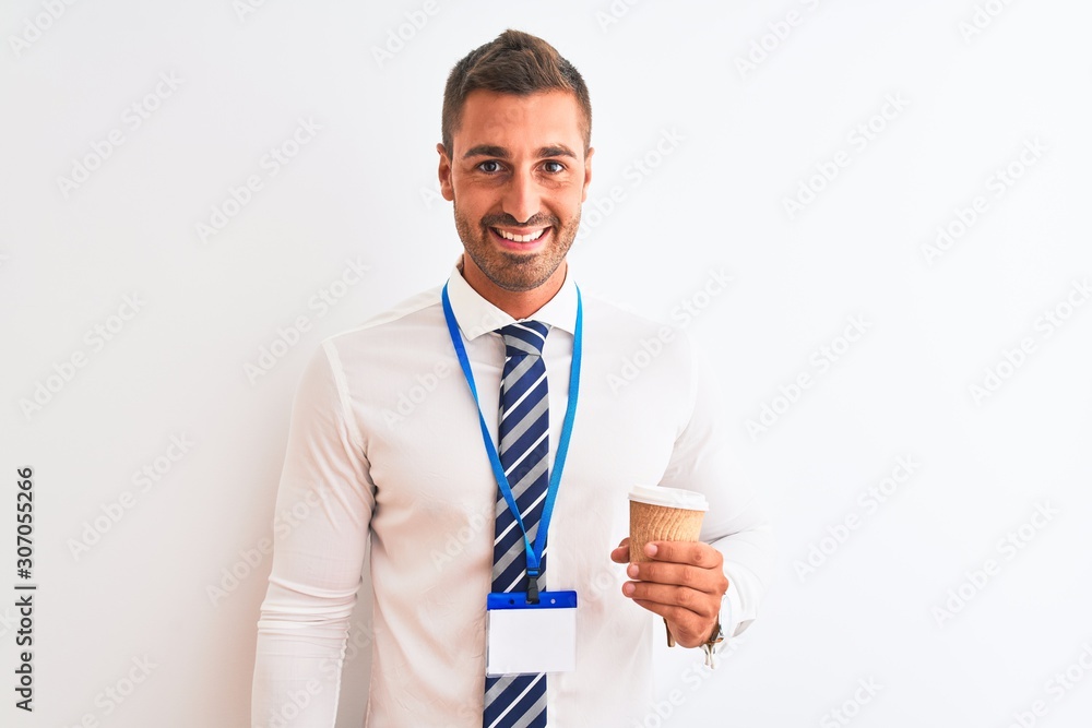 Young handsome business man wearing id pass and drinking coffee over isolated background with a happy face standing and smiling with a confident smile showing teeth Young handsome business man wearing id pass and drinking coffee over isolated background with a happy face standing and smiling with a confident smile showing teeth