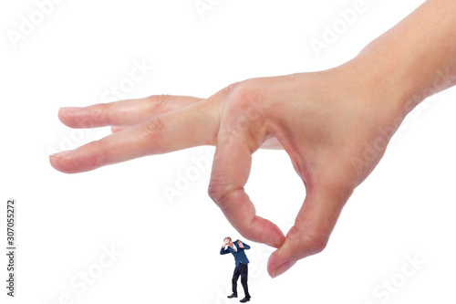 Gigantic woman holding a tiny little businessman as a metaphor for loss of self-confidence.  The man is feeling vulnerable and defenseless isolated on a white background