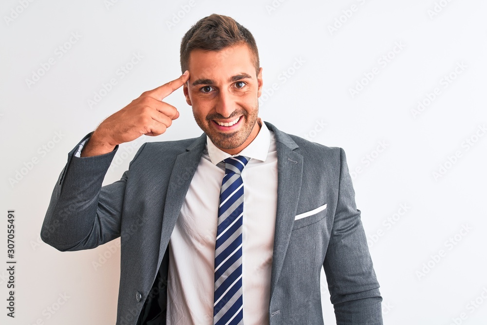 Young handsome business man wearing suit and tie over isolated background Smiling pointing to head with one finger, great idea or thought, good memory Young handsome business man wearing suit and tie over isolated background Smiling pointing to head with one finger, great idea or thought, good memory
