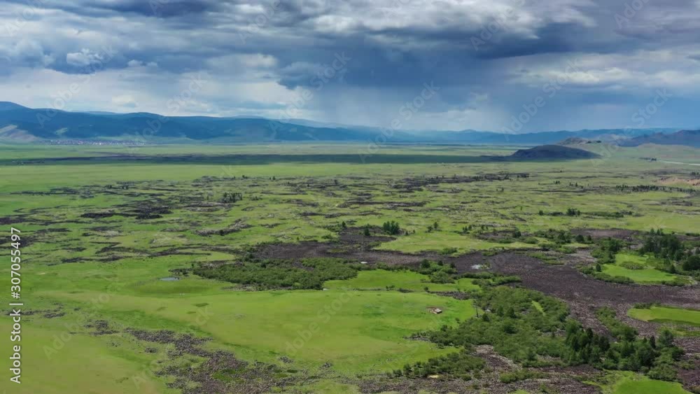 Aerial view of steppe and mountains with rain landscape in Orkhon valley, Mongolia, 4k Aerial view of steppe and mountains with rain landscape in Orkhon valley, Mongolia, 4k