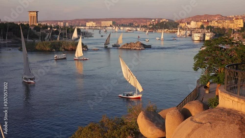 Beautiful landscape with felucca boats on Nile river in Aswan at sunset, Egypt, 4k photo