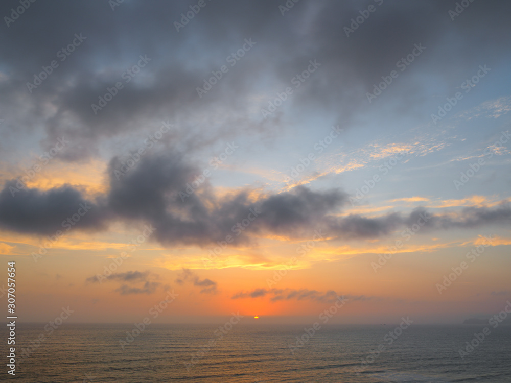 Naklejka premium View of a sunset on the coast of the city of Lima