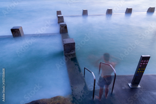 Sea pool at dawn with a ghost swimmer