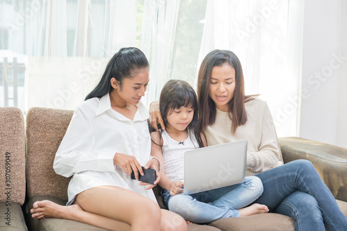 family mother and child daughter at home with a laptop
