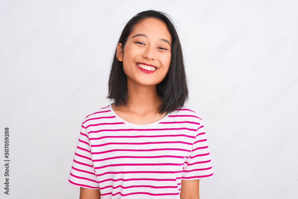 Young chinese woman wearing striped t-shirt standing over isolated white background with a happy and cool smile on face. Lucky person. Young chinese woman wearing striped t-shirt standing over isolated white background with a happy and cool smile on face. Lucky person.