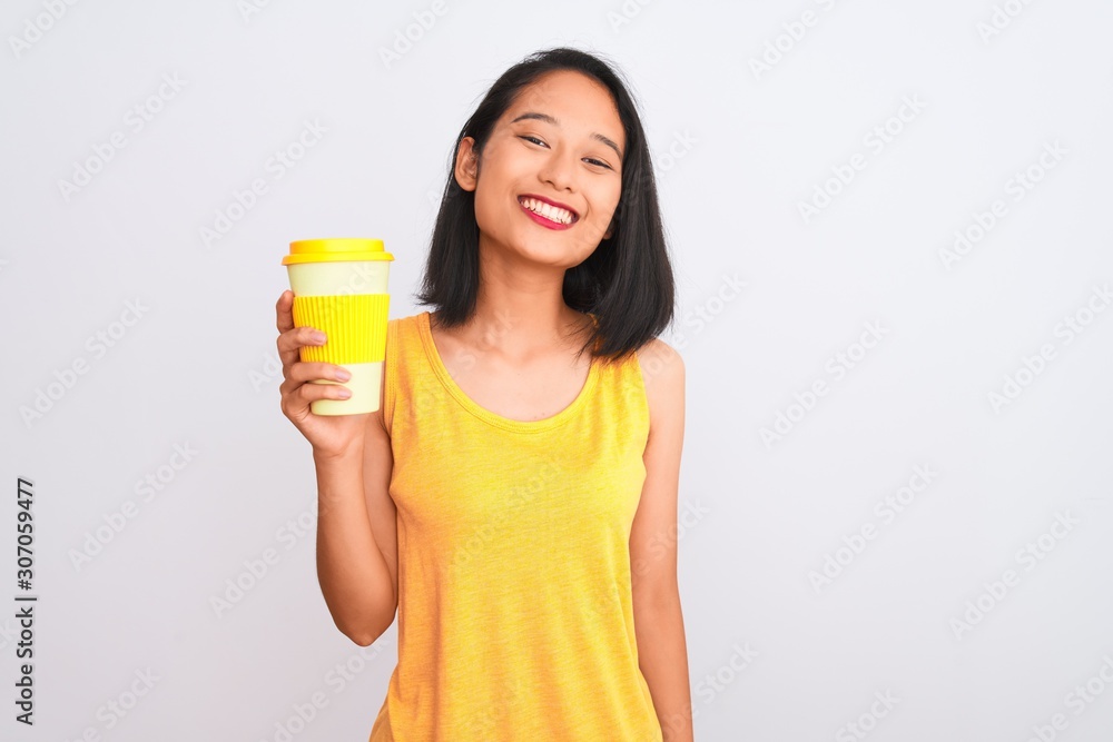 Young chinese woman drinking take away glass of coffee over isolated white background with a happy face standing and smiling with a confident smile showing teeth Young chinese woman drinking take away glass of coffee over isolated white background with a happy face standing and smiling with a confident smile showing teeth