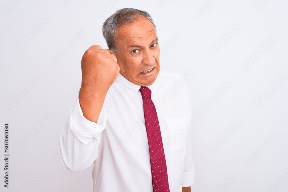 Senior grey-haired businessman wearing elegant tie over isolated white background angry and mad raising fist frustrated and furious while shouting with anger. Rage and aggressive concept. Senior grey-haired businessman wearing elegant tie over isolated white background angry and mad raising fist frustrated and furious while shouting with anger. Rage and aggressive concept.