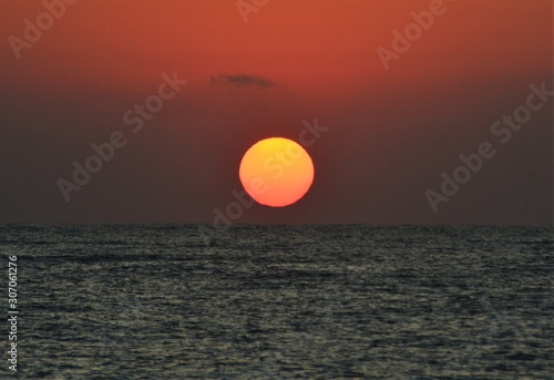 the sun like a ball rising from the sea © sebi_2569