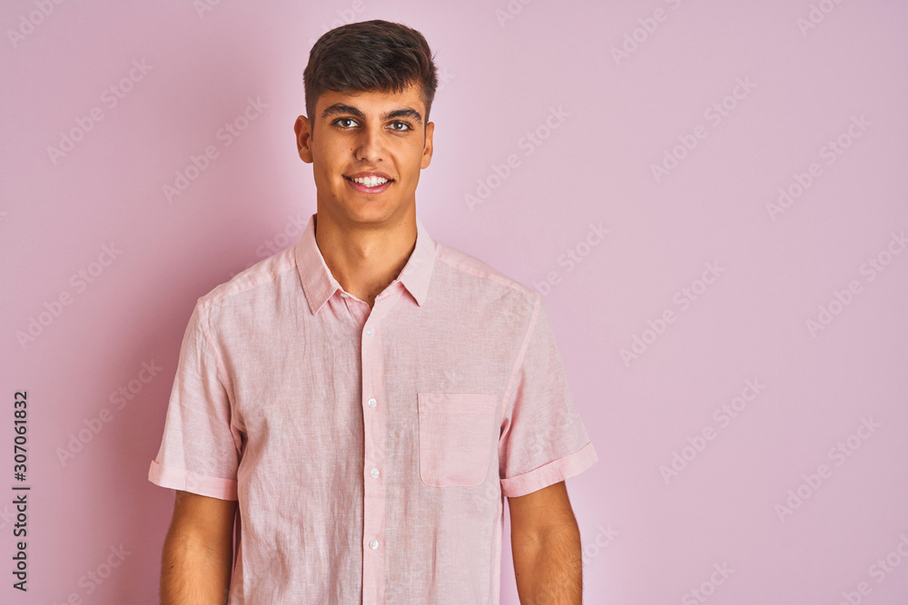 Young indian man wearing casual shirt standing over isolated pink background with a happy and cool smile on face. Lucky person. Young indian man wearing casual shirt standing over isolated pink background with a happy and cool smile on face. Lucky person.