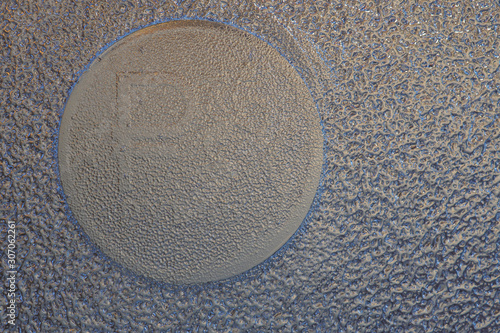 Wallpaper Mural An imprint on the ice of a Russian coin of one ruble with the symbol of the national currency. Dark background or wallpaper. Blue and brown. Economics and finance of Russia. Reduced contrast. Macro Torontodigital.ca