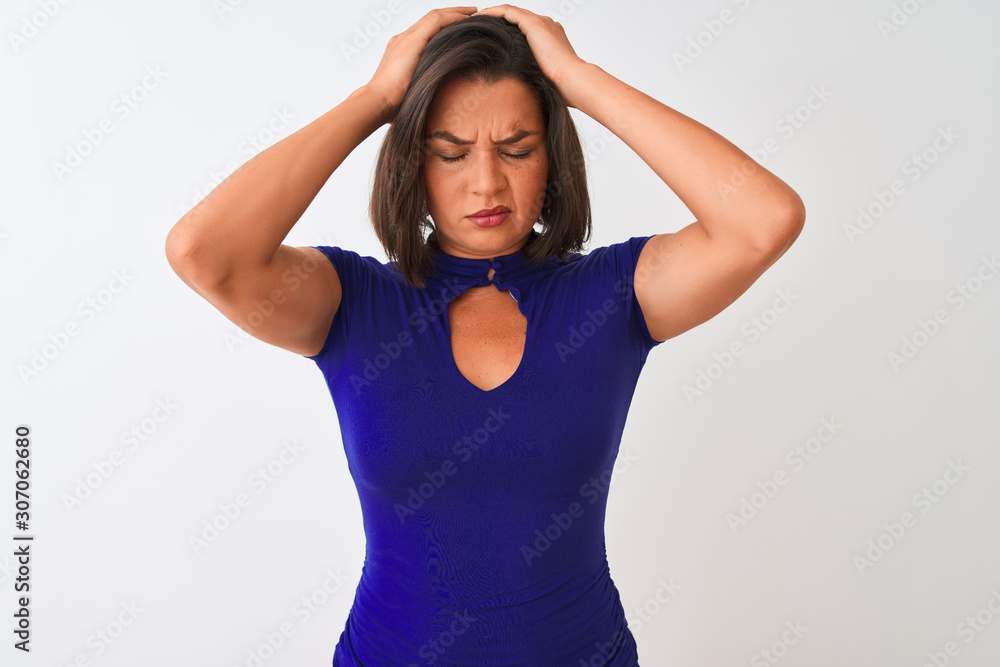 Young beautiful woman wearing blue elegant t-shirt standing over isolated white background suffering from headache desperate and stressed because pain and migraine. Hands on head. Young beautiful woman wearing blue elegant t-shirt standing over isolated white background suffering from headache desperate and stressed because pain and migraine. Hands on head.