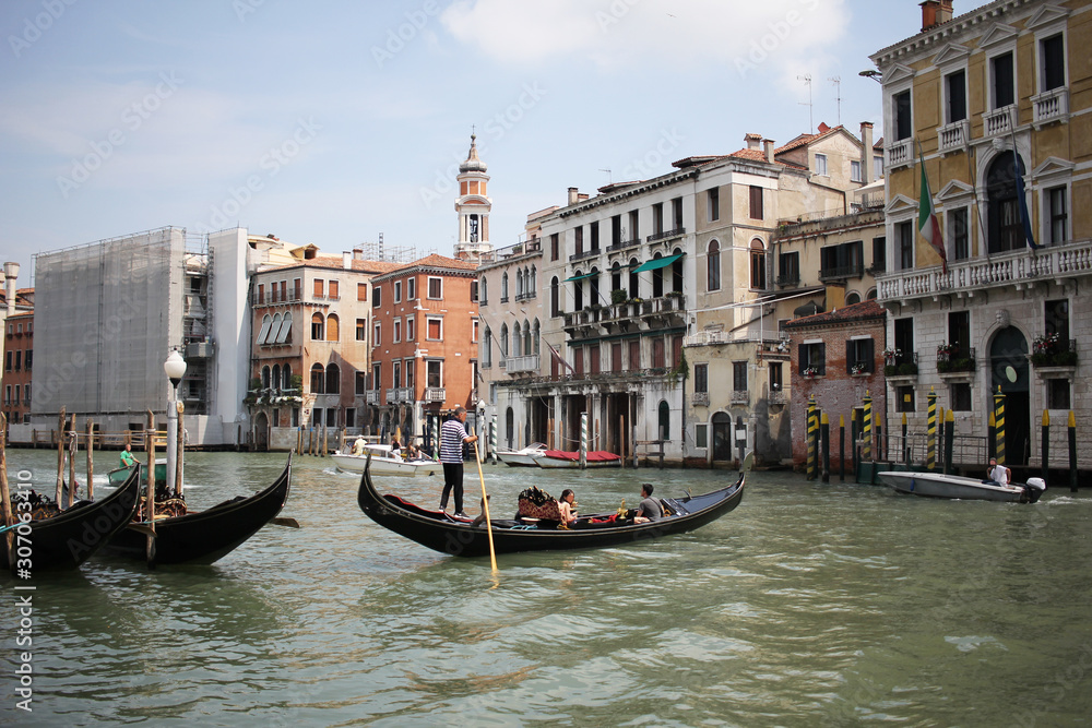 Gondolas travelling on Grand Canal Venice surrounding by historical attractive building, Venice, Italy, Commercial advertisement for day trip boat in Europe