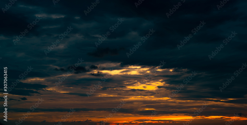 Beautiful sunset sky. Orange, blue, and white sky. Colorful sunset. Art picture of sky at sunset. Sunset and clouds for inspiration background. Nature background. Peaceful and tranquil concept.