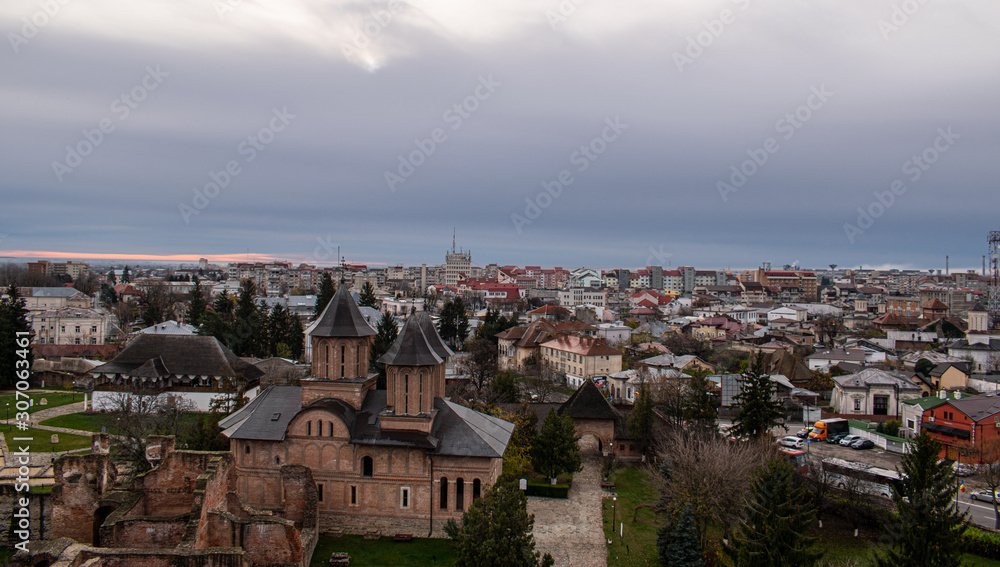Beautiful view of a monastery and the city of Targoviste, Romania seen from atop of the Chindia Tower, on a cloudy autumn day