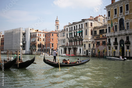 Gondolas travelling on Grand Canal Venice surrounding by historical attractive building  Venice  Italy  Commercial advertisement for day trip boat in Europe