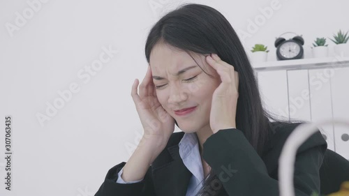 Young asian businesswoman having headache while working in office