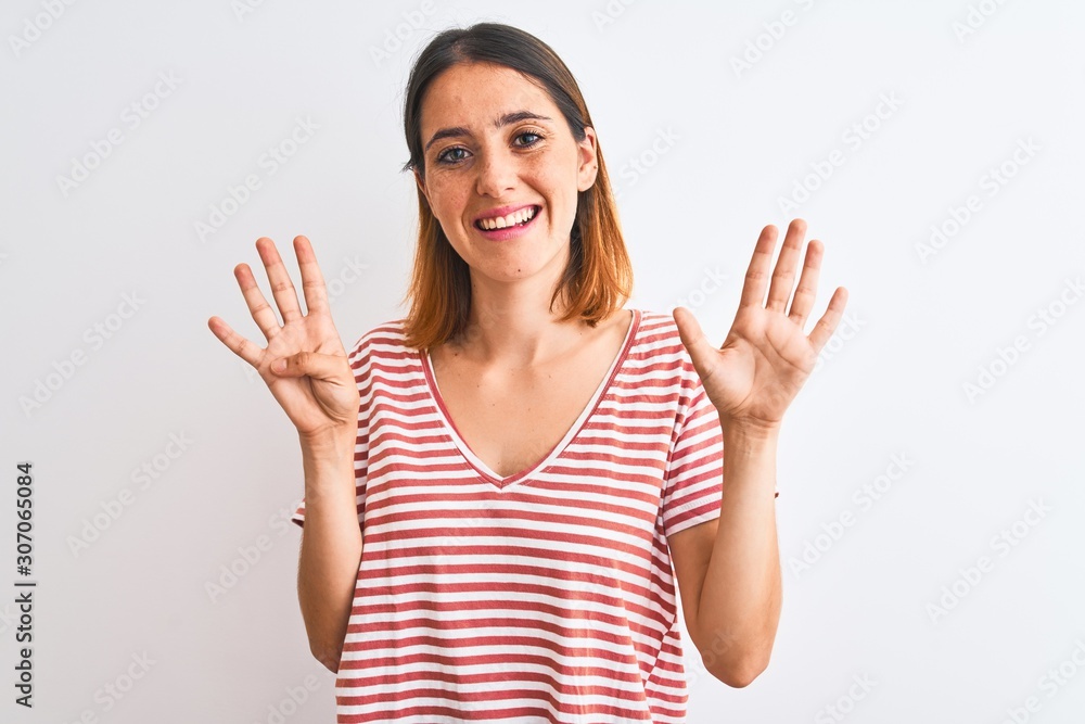 Beautiful redhead woman wearing casual striped red t-shirt over isolated background showing and pointing up with fingers number nine while smiling confident and happy. Beautiful redhead woman wearing casual striped red t-shirt over isolated background showing and pointing up with fingers number nine while smiling confident and happy.