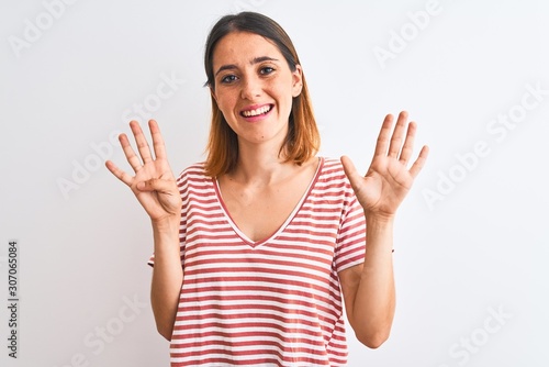 Beautiful redhead woman wearing casual striped red t-shirt over isolated background showing and pointing up with fingers number nine while smiling confident and happy.