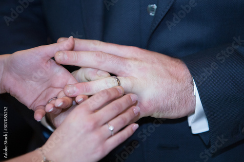 An unrecognizable bride and groom exchanging of the Wedding Rings in church during the christian wedding ceremony 