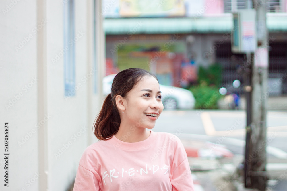 Young Asian woman beautiful looking away to side with smile on face, natural expression. Laughing confident.