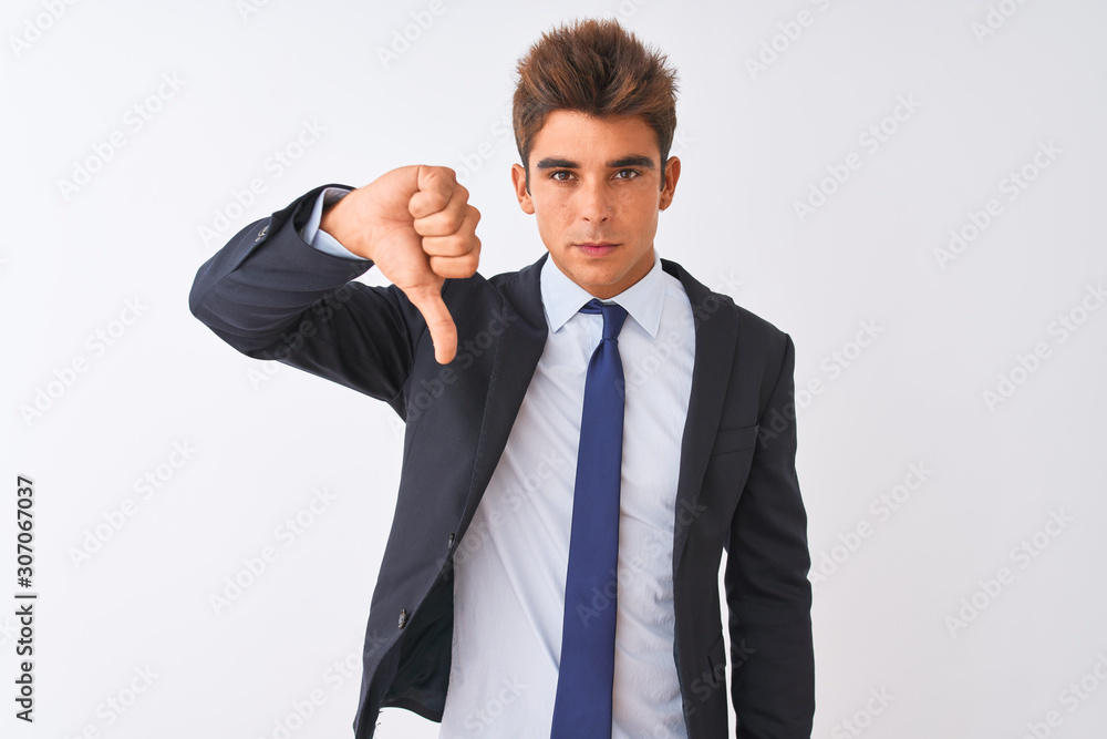 Young handsome businessman wearing suit standing over isolated white background looking unhappy and angry showing rejection and negative with thumbs down gesture. Bad expression. Young handsome businessman wearing suit standing over isolated white background looking unhappy and angry showing rejection and negative with thumbs down gesture. Bad expression.