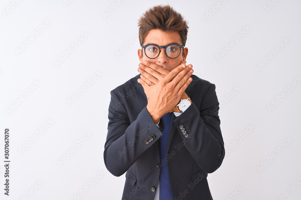 Young handsome businessman wearing suit and glasses over isolated white background shocked covering mouth with hands for mistake. Secret concept. Young handsome businessman wearing suit and glasses over isolated white background shocked covering mouth with hands for mistake. Secret concept.