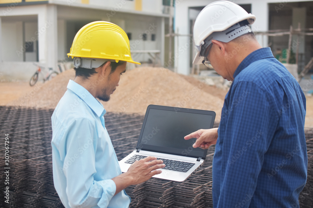 Engineering use computer at work building construction background Engineering use computer at work building construction background