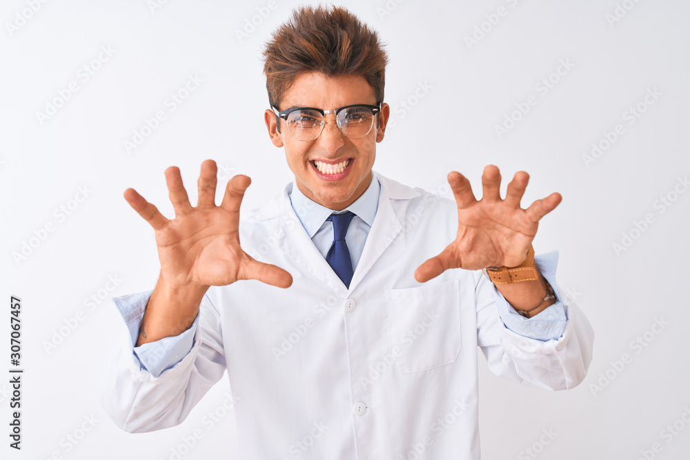 Young handsome sciencist man wearing glasses and coat over isolated white background smiling funny doing claw gesture as cat, aggressive and sexy expression Young handsome sciencist man wearing glasses and coat over isolated white background smiling funny doing claw gesture as cat, aggressive and sexy expression