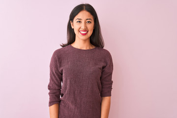 Young chinese woman wearing purple sweater standing over isolated pink background with a happy and cool smile on face. Lucky person.