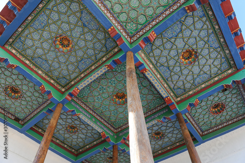 The ceiling in the form of a dome in a traditional ancient Asian mosaic. The details of the architecture of medieval Central Asia