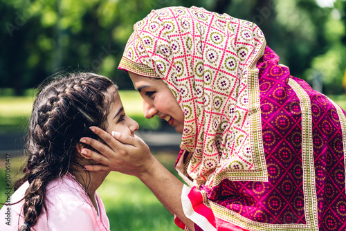 Obraz na plátně Portrait of happy lovely family arabic muslim mother and little muslim girls chi