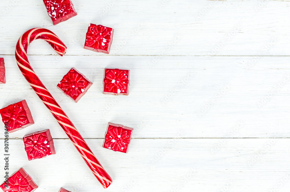 Fototapeta premium Christmas. New Year's Eve. Background. red candy in the form of gifts on a white background