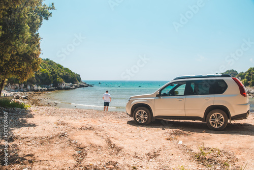 car travel concept man at summer beach looking at sea © phpetrunina14