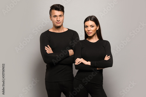 Foto Couple wearing thermal underwear on grey background