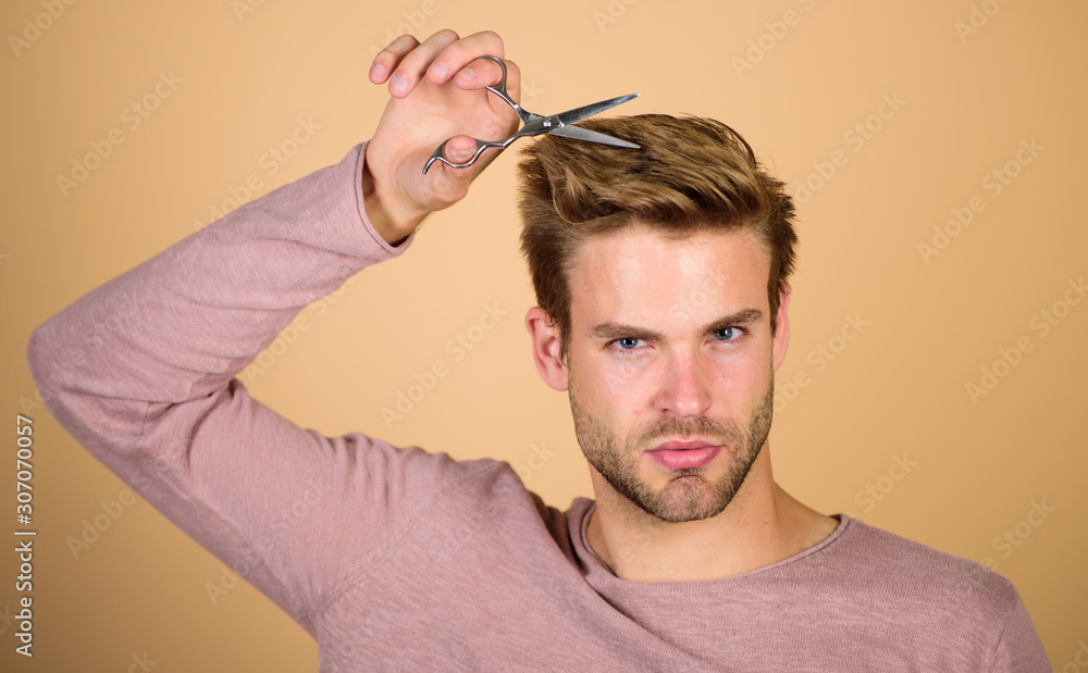 Fototapeta premium Cut bangs. Fashion and beauty. Fresh hairstyle. Barbershop concept. Barbershop salon. Personal stylist. Bearded man hold scissors. Modern barbershop. Hipster with tool. Designing haircut. Facial care