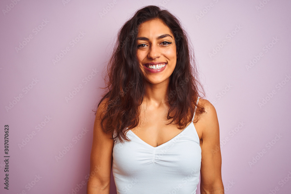 Young beautiful woman wearing white t-shirt standing over isolated pink background with a happy and cool smile on face. Lucky person. Young beautiful woman wearing white t-shirt standing over isolated pink background with a happy and cool smile on face. Lucky person.
