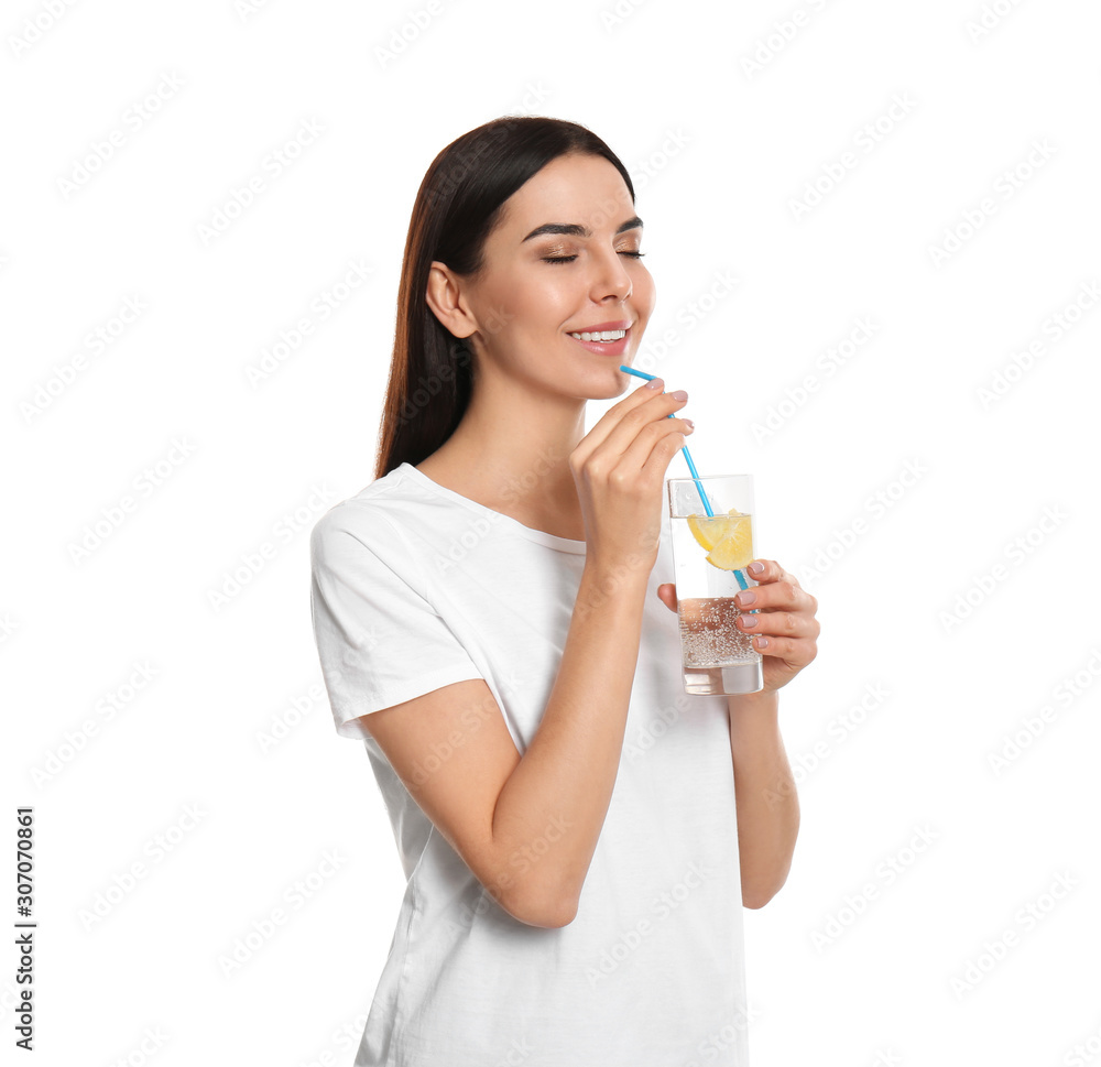 Beautiful young woman drinking tasty lemon water on white background Beautiful young woman drinking tasty lemon water on white background