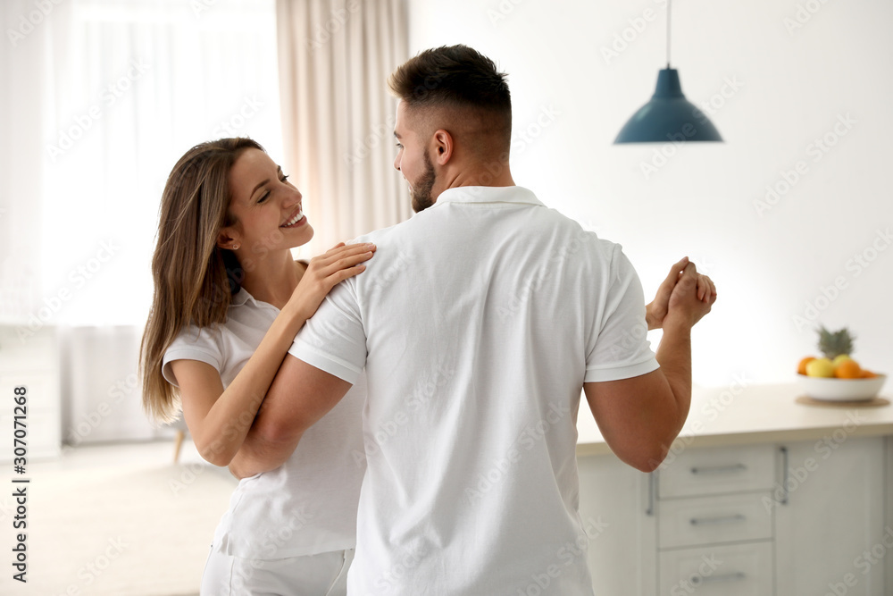Lovely young couple dancing together at home Lovely young couple dancing together at home