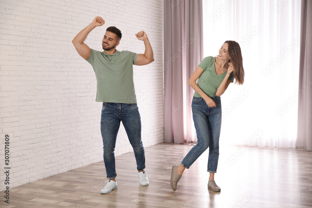 Lovely young couple dancing together at home Lovely young couple dancing together at home