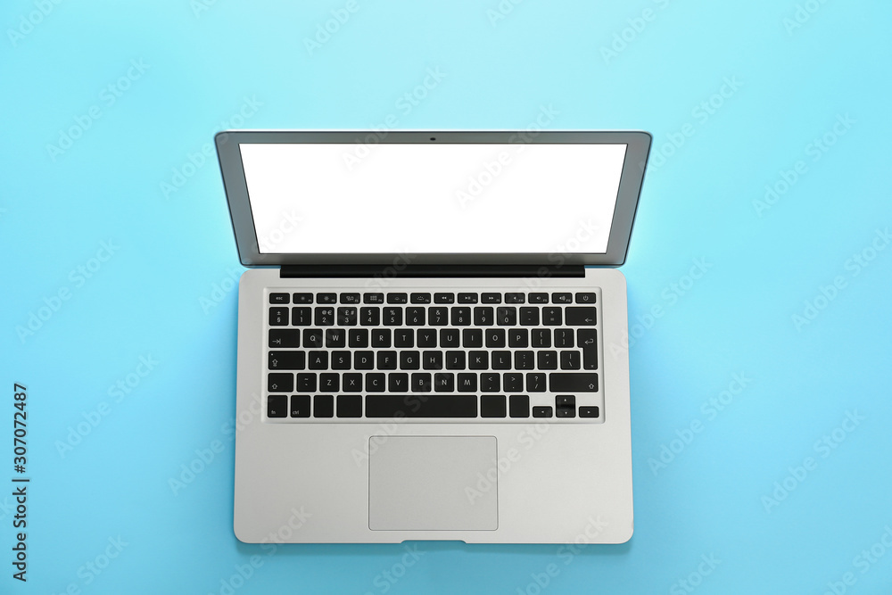 Modern laptop with blank screen on light blue background, top view Modern laptop with blank screen on light blue background, top view