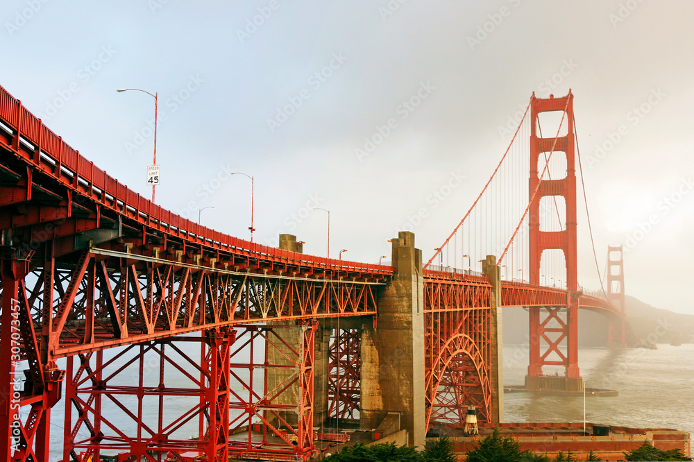 Golden gate bridge in San Francisco at sunset with cloudy day. Having some copy space for design.