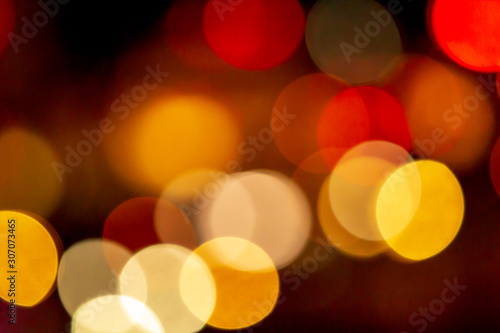 Bokeh abstract blur from street or road lights and car at night of the city or town. © Phongsak
