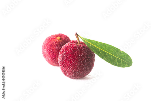 A few bayberries with a green leaf on a white background