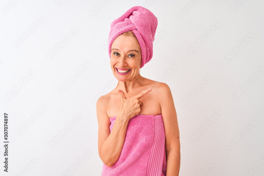 Middle age woman wearing shower towel after bath standing over isolated white background cheerful with a smile of face pointing with hand and finger up to the side with happy and natural expression Middle age woman wearing shower towel after bath standing over isolated white background cheerful with a smile of face pointing with hand and finger up to the side with happy and natural expression