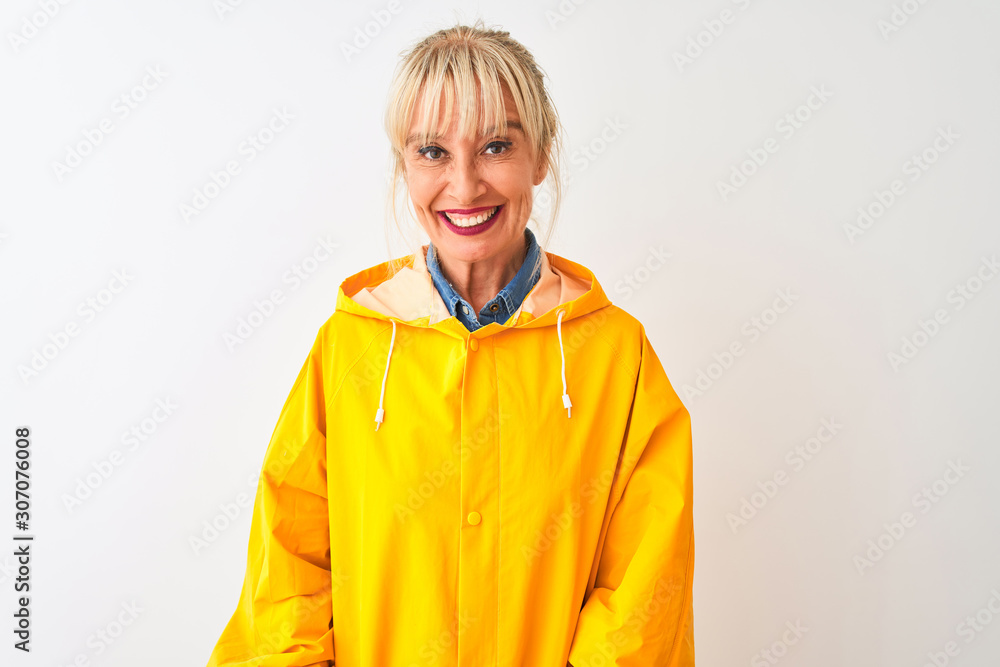 Middle age woman wearing yellow rain coat standing over isolated white background with a happy and cool smile on face. Lucky person. Middle age woman wearing yellow rain coat standing over isolated white background with a happy and cool smile on face. Lucky person.