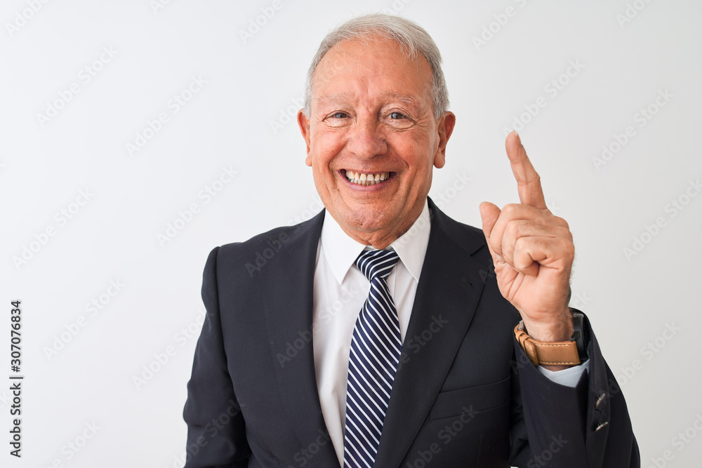 Senior grey-haired businessman wearing suit standing over isolated white background showing and pointing up with finger number one while smiling confident and happy. Senior grey-haired businessman wearing suit standing over isolated white background showing and pointing up with finger number one while smiling confident and happy.