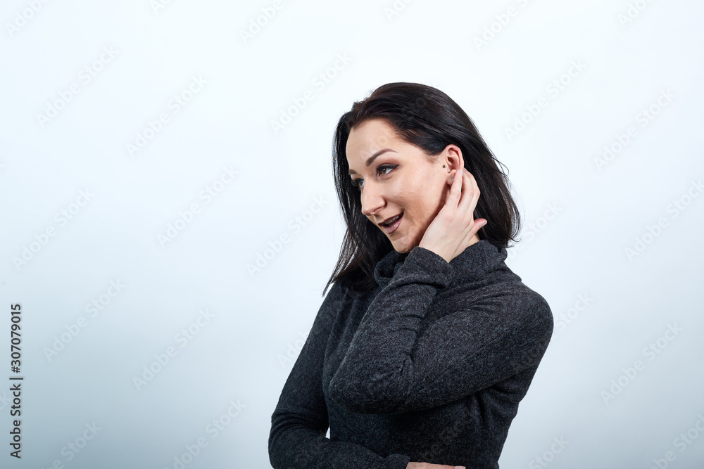 Attractive caucasian young woman in fashion black sweater correcting haircut over isolated white background, Lifestyle concept Attractive caucasian young woman in fashion black sweater correcting haircut over isolated white background, Lifestyle concept