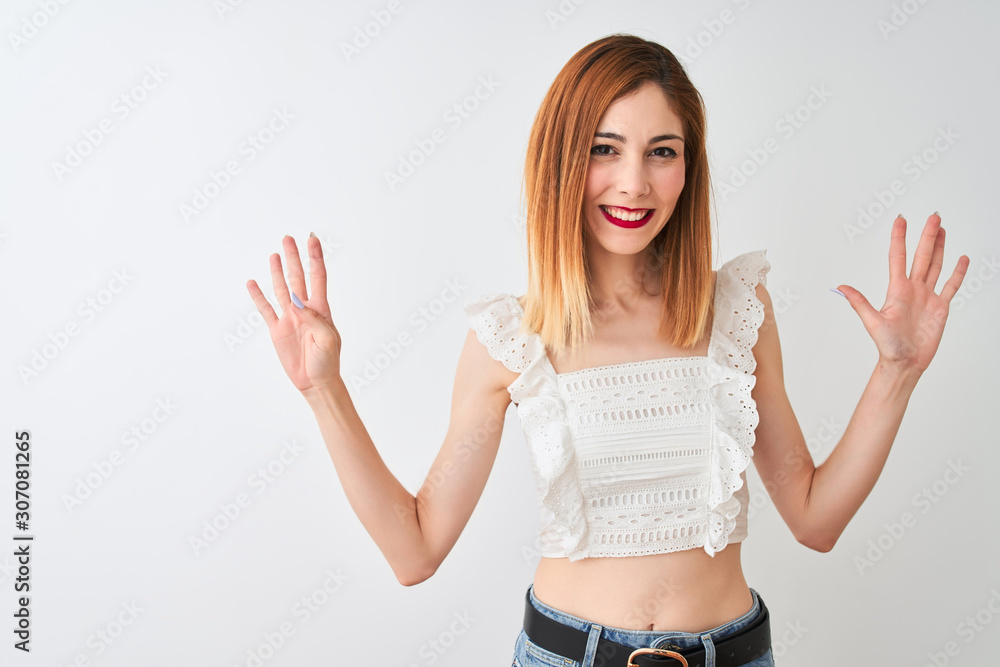 Beautiful redhead woman wearing casual t-shirt standing over isolated white background showing and pointing up with fingers number nine while smiling confident and happy. Beautiful redhead woman wearing casual t-shirt standing over isolated white background showing and pointing up with fingers number nine while smiling confident and happy.