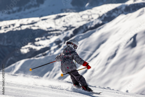 Child getting off the track on fresh snow in beautiful sunny cold day