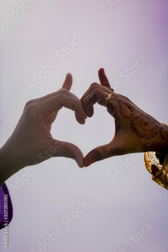 Fototapeta Naklejka Na Ścianę i Meble -  A Man and Woman Posing hands Like Heart Shape.